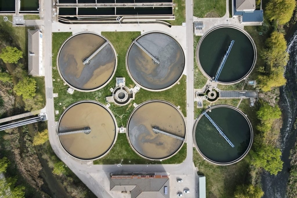 Aerial top view of round polls in wastewater treatment plant, filtration of dirty or sewage water.